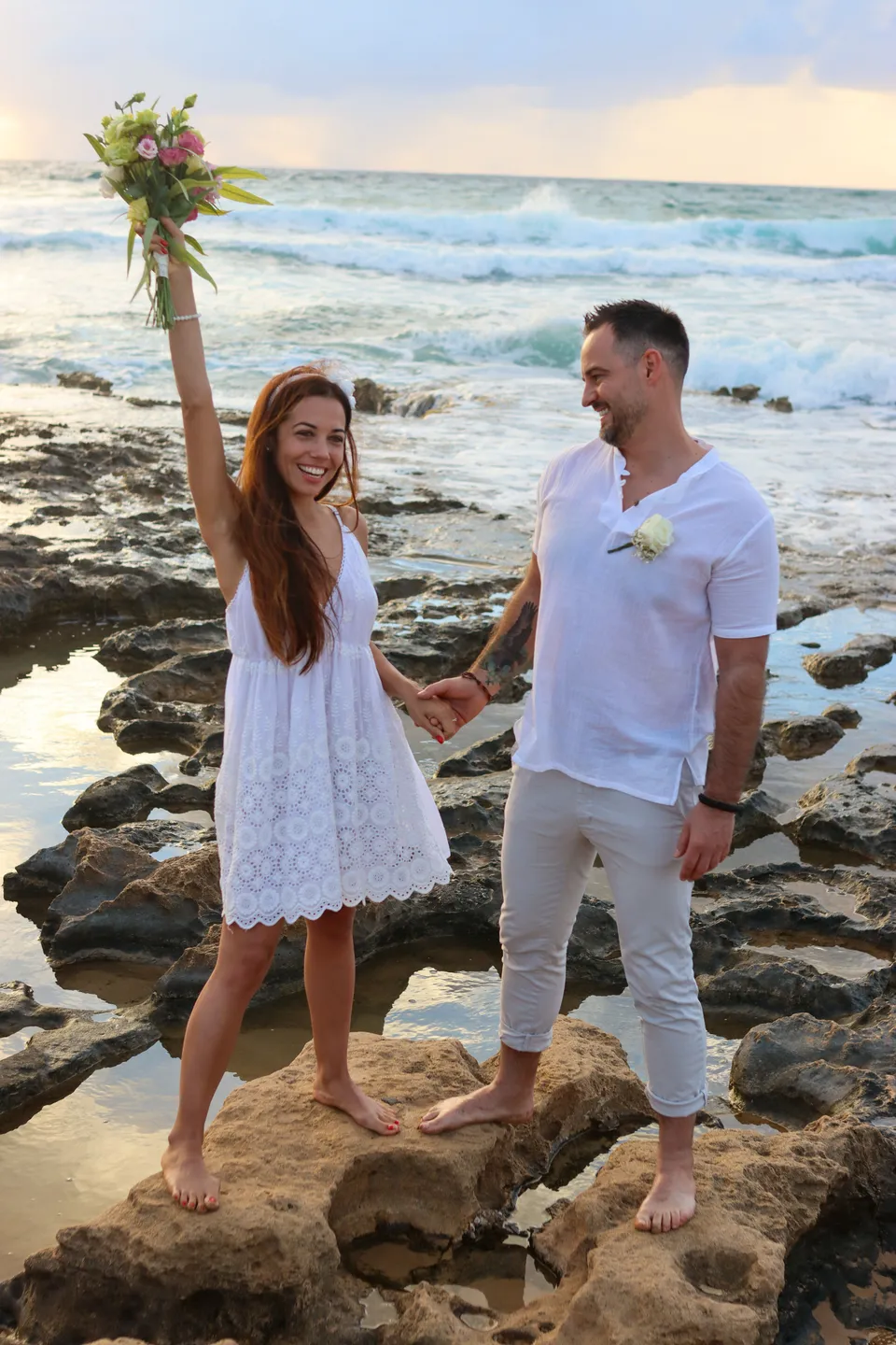 Couple celebrating on the rocks