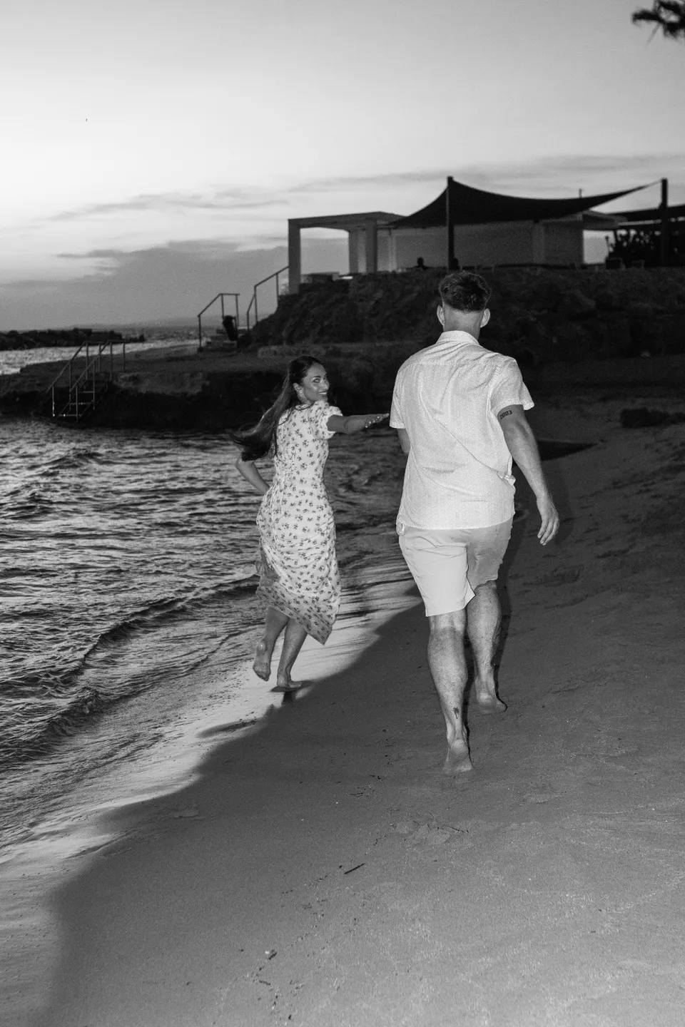 Running along the shore in black and white