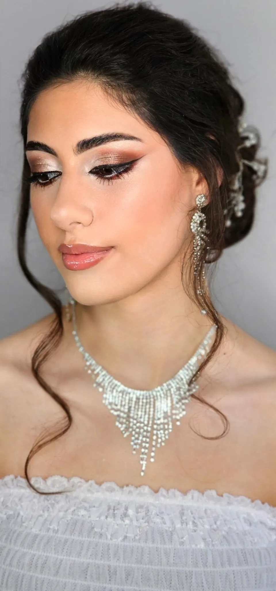Loose updo with curled tendrils