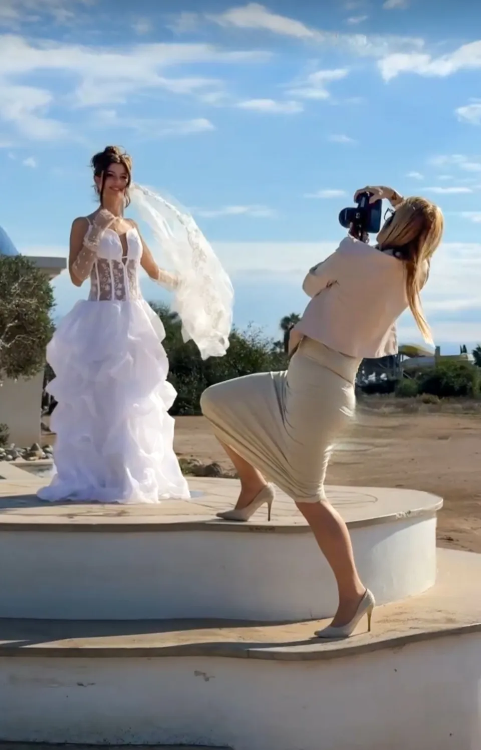 Kriszta photographing a bride by the sea