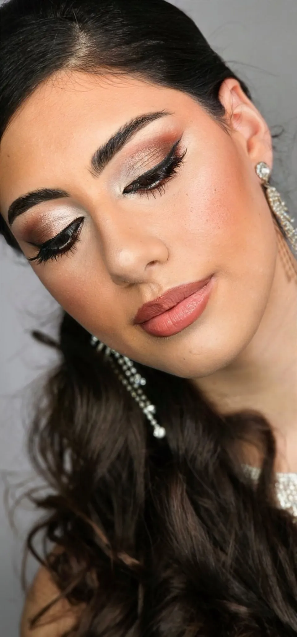Winged liner bridal look with drop earrings