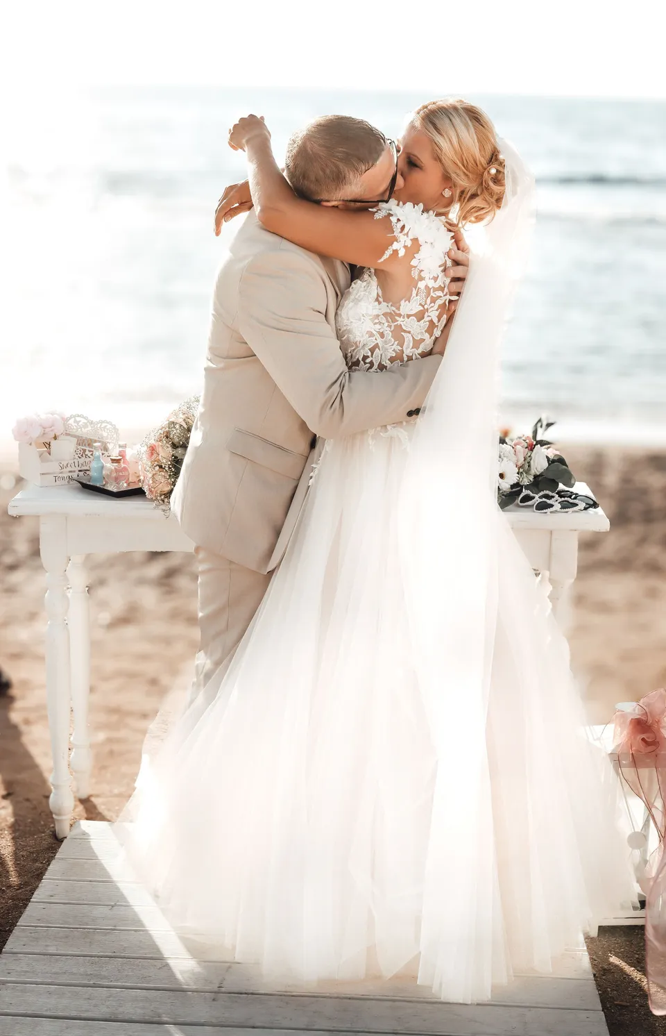 Couple embracing at a beach ceremony