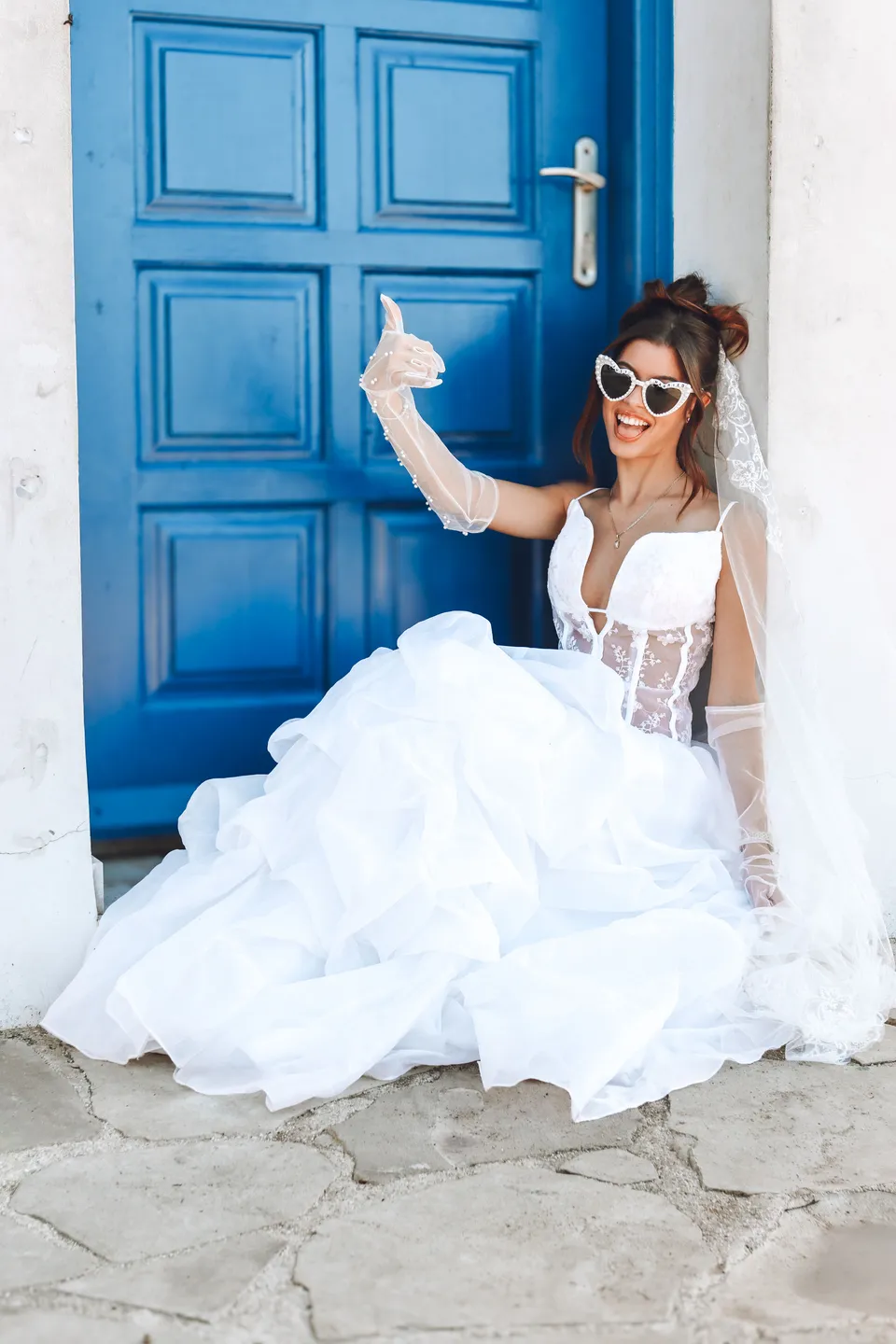Bride laughing by a blue door