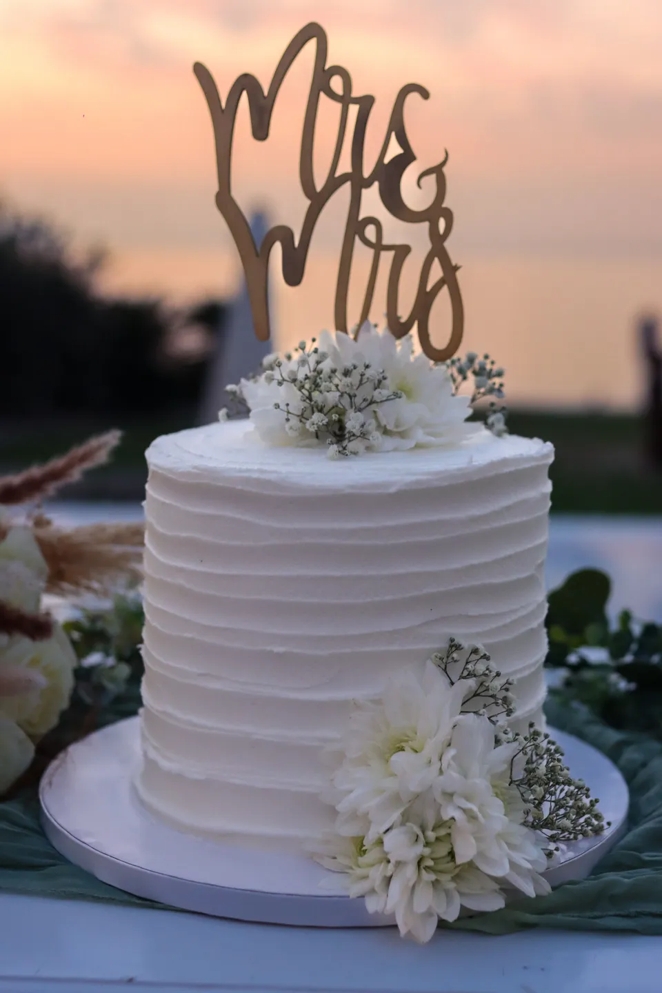 Wedding cake with Mr and Mrs topper at sunset
