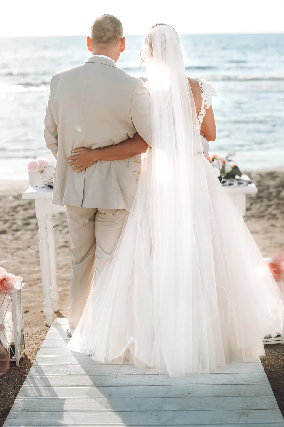 Couple walking down a jetty aisle