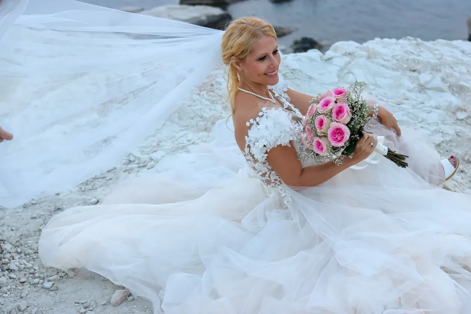 Bride sitting in a cloud of tulle with roses