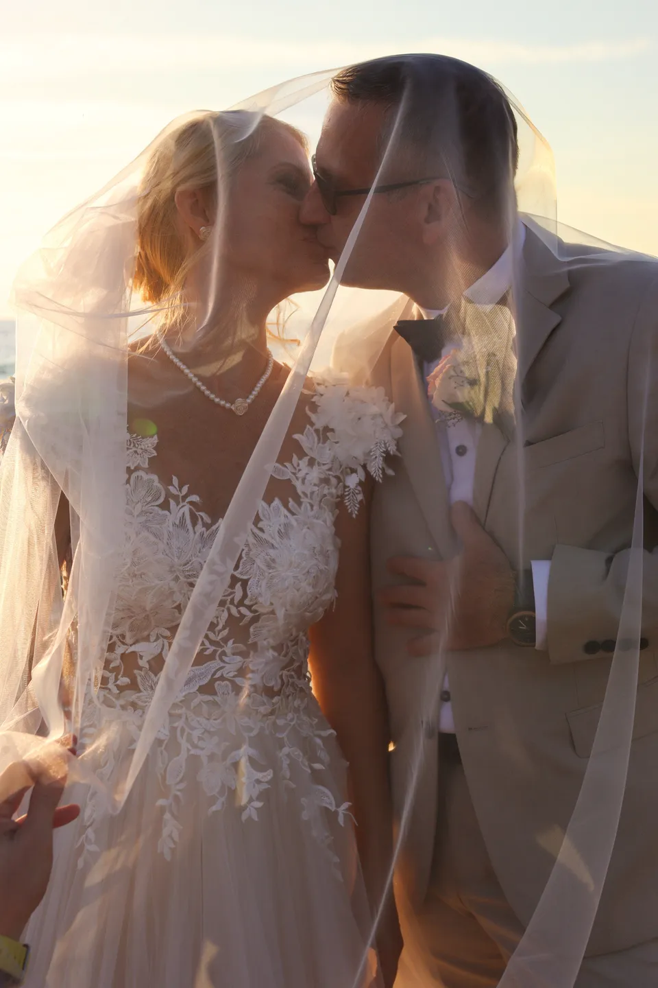 Kiss under the veil at sunset