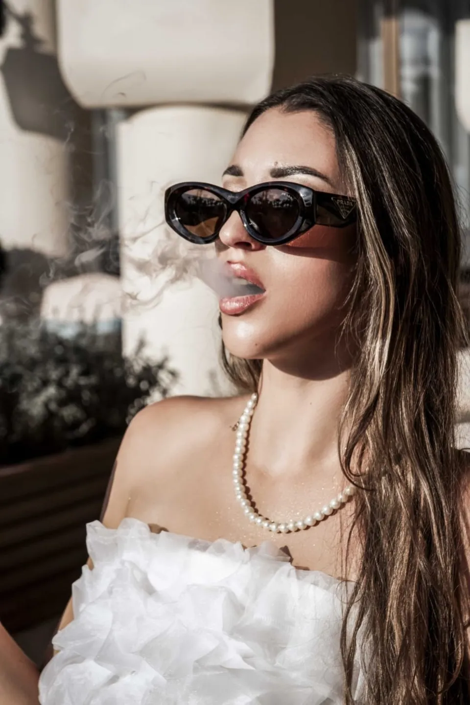 Portrait with sunglasses and pearls