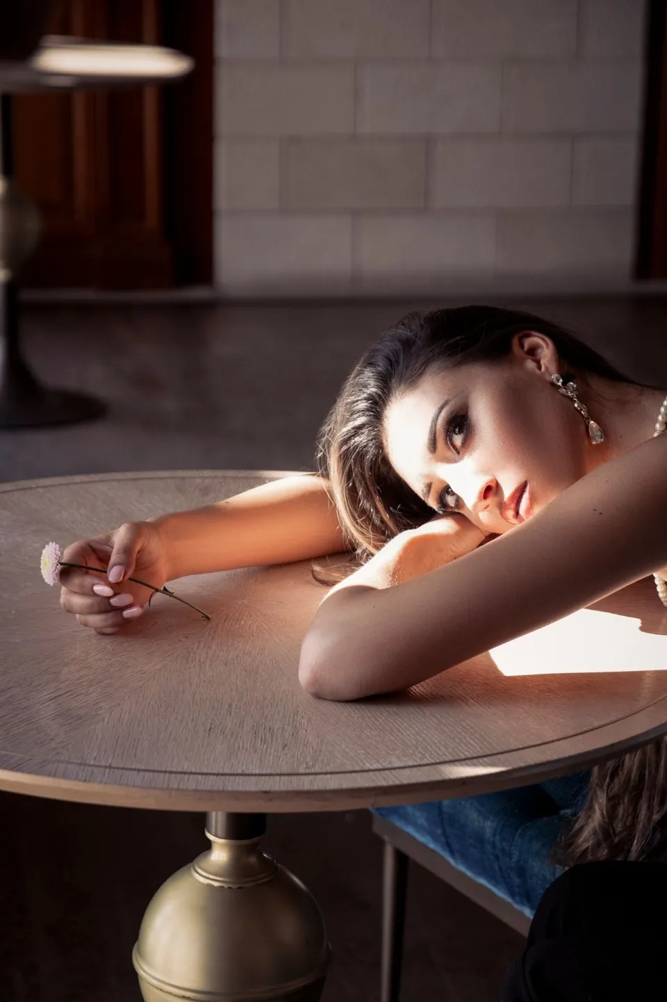 Window light portrait at a table