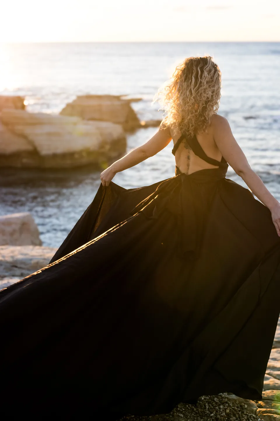 Black gown on the rocks by the sea